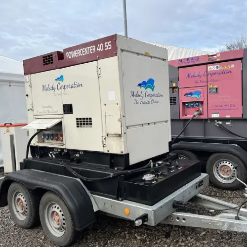 Two large, portable generator hire melody corporation units mounted on trailers at an outdoor location.